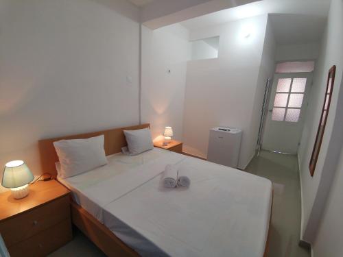 a bedroom with a bed with two shoes on it at Plateau Bedroom & Chambre - Praia Center 1 in Praia