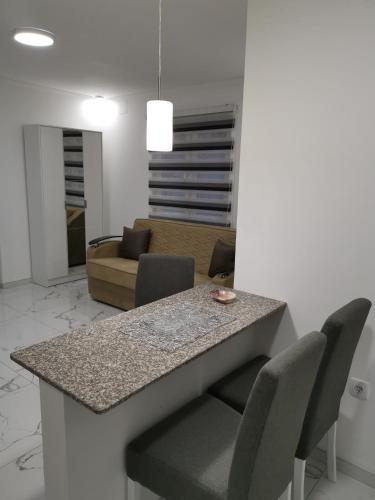 a kitchen and living room with a table and chairs at Studio Aleks 2 in Banja Koviljača