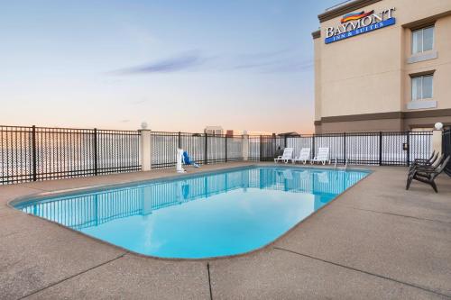a swimming pool in front of a hotel at Baymont by Wyndham Evansville East in Evansville