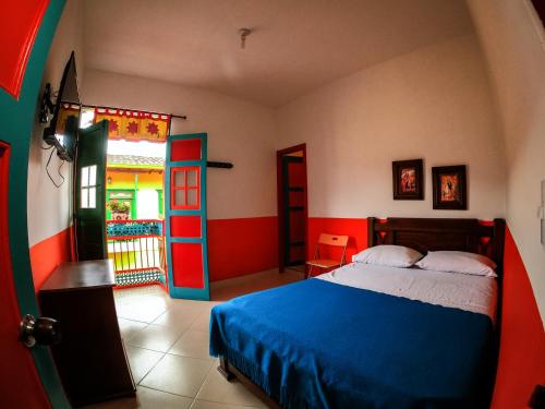 a bedroom with a bed and a door to a patio at Jardín by Bernalo Hotels in Jardin