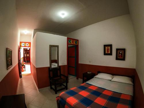 a bedroom with a bed and a chair in it at Jardín by Bernalo Hotels in Jardin