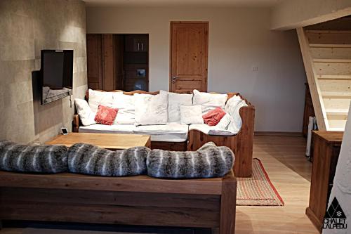 a living room with a couch and a table at Chalet LALPEDU in L'Alpe-d'Huez