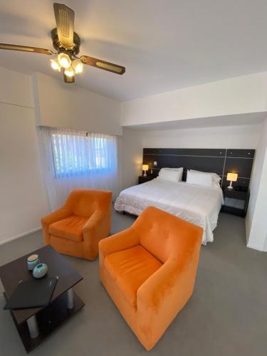 Postel nebo postele na pokoji v ubytování Montecarlo Hotel & Apart