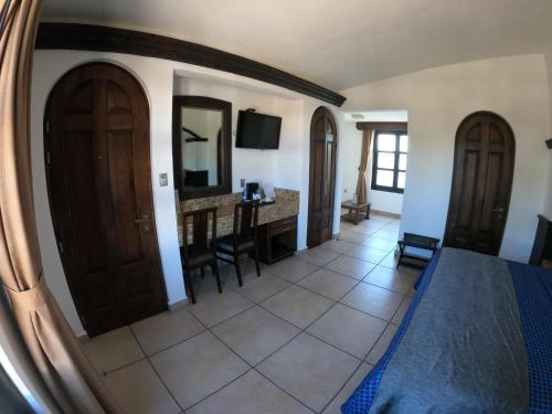 a room with a bed and a desk and a mirror at The Latit Hotel Querétaro in Querétaro