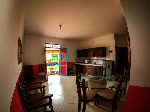 a kitchen with a glass table and wooden chairs at Jardín by Bernalo Hotels in Jardin