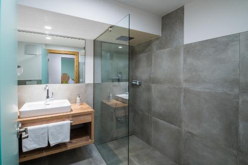 a bathroom with a sink and a shower at Gasthof Herrnhaus in Brixlegg