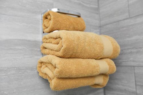 a stack of brown towels sitting on a wall at Raynolds Cottage Blidworth in Blidworth