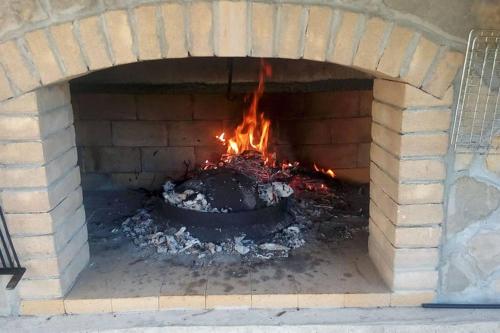 a brick oven with a fire in it at Villa Lana in Crivac