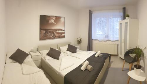 a living room with a bed with teddy bears on it at Mistel Apartman in Bodensdorf