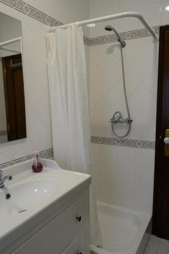 a bathroom with a shower curtain and a sink at Casal dos Cantos in Quinta do Anjo