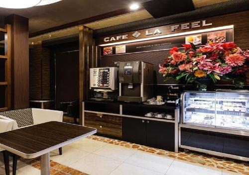 a restaurant with a cafe la feel with a table and flowers at Hotel Feel / Vacation STAY 63700 in Yokohama