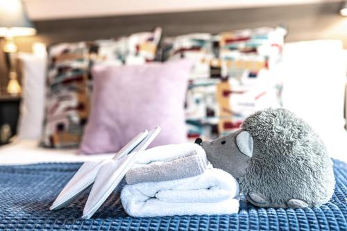 a stuffed animal sitting on a bed with a pair of scissors at Caravogue House in Trim