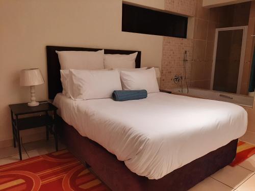a bedroom with a large bed with white pillows at Whale Rock in Margate