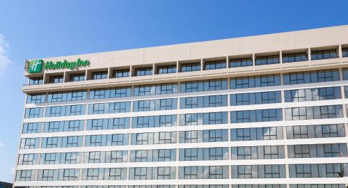a building with a sign on the top of it at Holiday Inn Miami West - Airport Area by IHG in Hialeah Gardens
