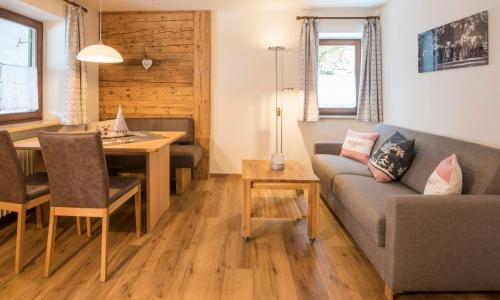 a living room with a couch and a table at Gschwenderhaus Ferienwohnungen in Oberstdorf