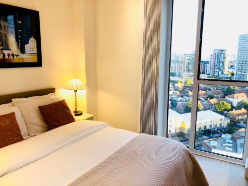 a bedroom with a bed and a large window at Luxury Lodge Excel London in Moffat