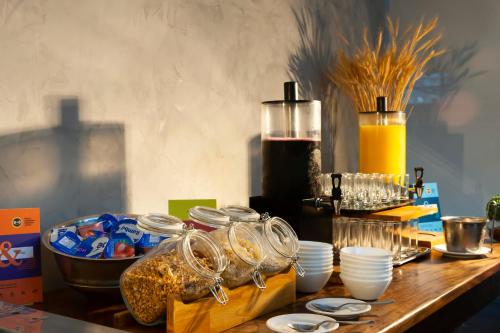 a wooden table topped with glasses and dishes on a counter at B&B HOTEL Uberlândia in Uberlândia