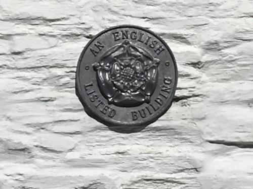 a sign for the new england energy company on a wall at Charming Devon Cottage near Quay-Rain Shower, Restaurants & Free Parking in Kingsbridge