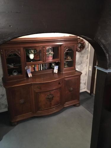 a wooden cabinet in a room with an archway at Hostaria del Castello in Marburg an der Lahn