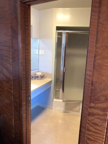 a bathroom with a shower and a sink at Curly Redwood Lodge in Crescent City