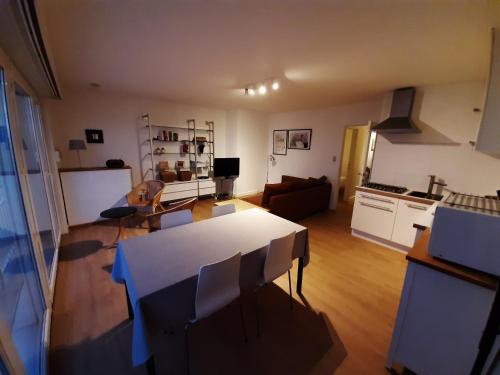 a kitchen and living room with a table and chairs at Sealview Nevada in Koksijde
