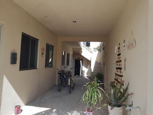 a hallway of a building with a bike parked next to it at El Padrino in Akumal