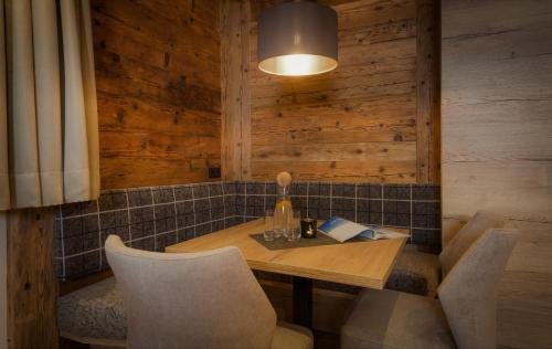 a dining room with a wooden table and chairs at NATURPARKGUT - alpdeluxe Apartments in Holzgau