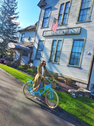 a woman riding a bike in front of a building at Chambery Inn in Lee