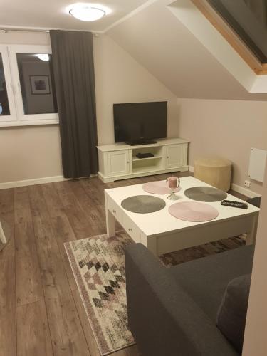 a living room with a tv and a coffee table at Eidsvoll Myrer in Eidsvoll