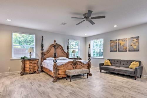 a bedroom with a bed and a couch and a fan at Jacksonville Gem - Ideal Location to Beaches! in Jacksonville