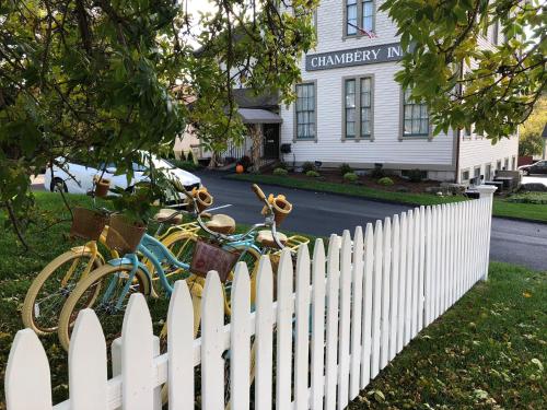 a white fence with bikes parked in front of a house at Chambery Inn in Lee