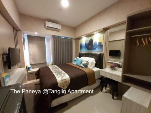 a hotel room with a bed and a bathroom at The Paneya @Tanglin Apartment in Surabaya