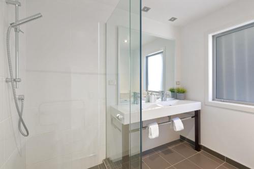 a bathroom with a sink and a glass shower at Ataahua in Queenstown