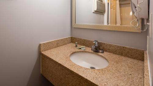 a bathroom counter with a sink and a mirror at Apple Valley Inn Pigeon Forge in Pigeon Forge