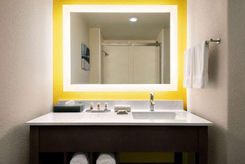 a bathroom with a sink and a mirror at La Quinta by Wyndham Clovis CA in Clovis