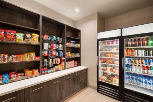 a kitchen with two refrigerators with food and drinks at La Quinta by Wyndham Clovis CA in Clovis