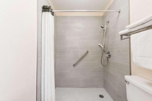 a bathroom with a shower with a shower curtain at Super 8 by Wyndham Waco/Mall area TX in Waco