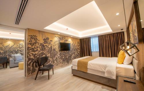 a hotel room with a bed and a tv at Almond Business Hotel in Nicosia