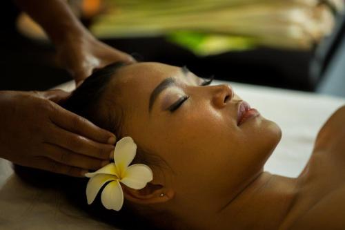 a woman getting a hair cut with a flower on her head at Siem Reap Palace Hotel & Spa in Siem Reap