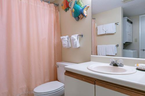 a bathroom with a sink and a toilet and a shower at Gulf Village #215 in Gulf Shores