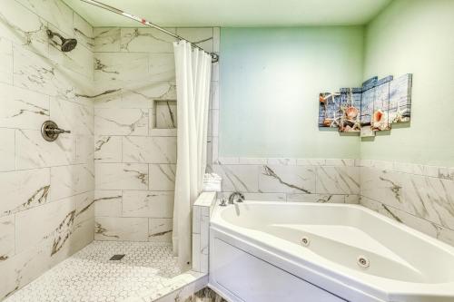 a white bathroom with a tub and a shower at San Carlos #1808 in Gulf Shores