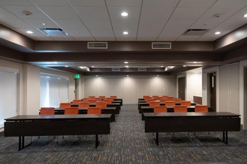 an empty conference room with orange chairs in it at Holiday Inn Express Boston by IHG in Boston
