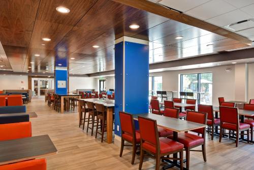 a dining room with wooden tables and chairs at Holiday Inn Express Boston, an IHG Hotel in Boston