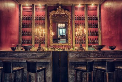 a bar in a room with a mirror and chairs at Paradise Road Tintagel Colombo in Colombo