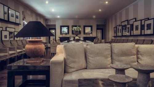 a living room with a couch and a table at Paradise Road Tintagel Colombo in Colombo