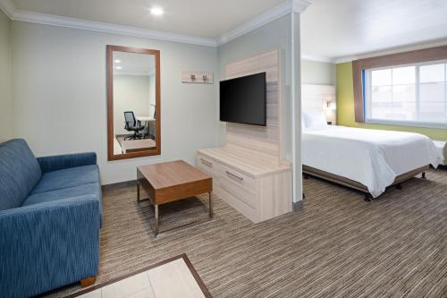 a hotel room with a bed and a television at Holiday Inn Express & Suites Watsonville by IHG in Watsonville