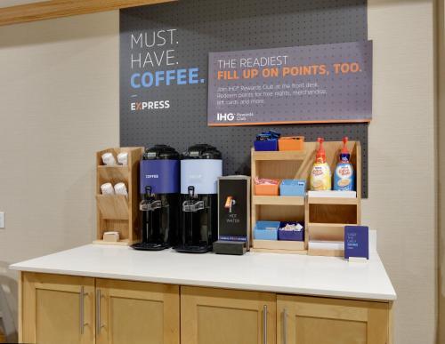 a counter with coffee products on it in a store at Holiday Inn Express & Suites San Antonio - Brooks City Base by IHG in San Antonio
