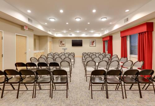 a room with a bunch of chairs and a screen at Holiday Inn Express & Suites San Antonio - Brooks City Base by IHG in San Antonio