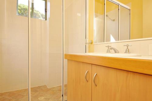 a bathroom with a sink and a shower at Tree Elle Retreat in Bow Bridge