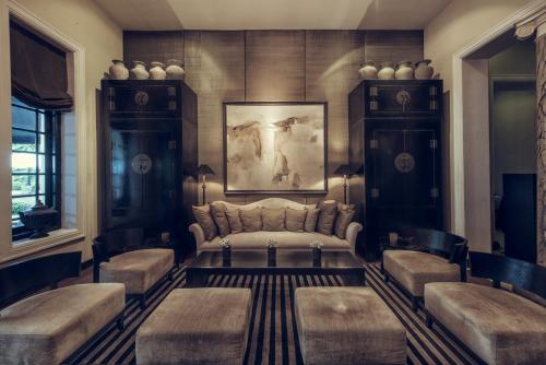 a living room with a couch and two stools at Paradise Road Tintagel Colombo in Colombo